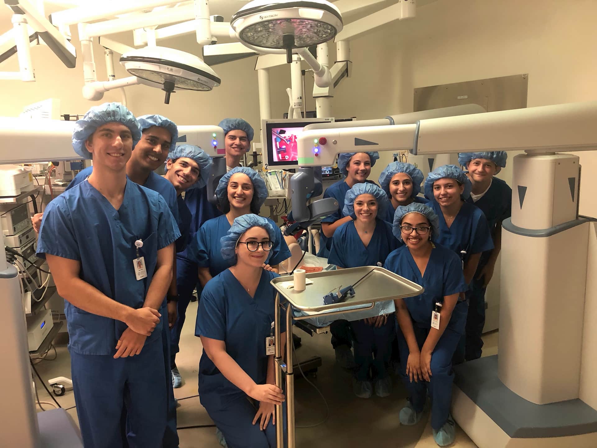 surgeons helping future doctors learn robotic surgery
